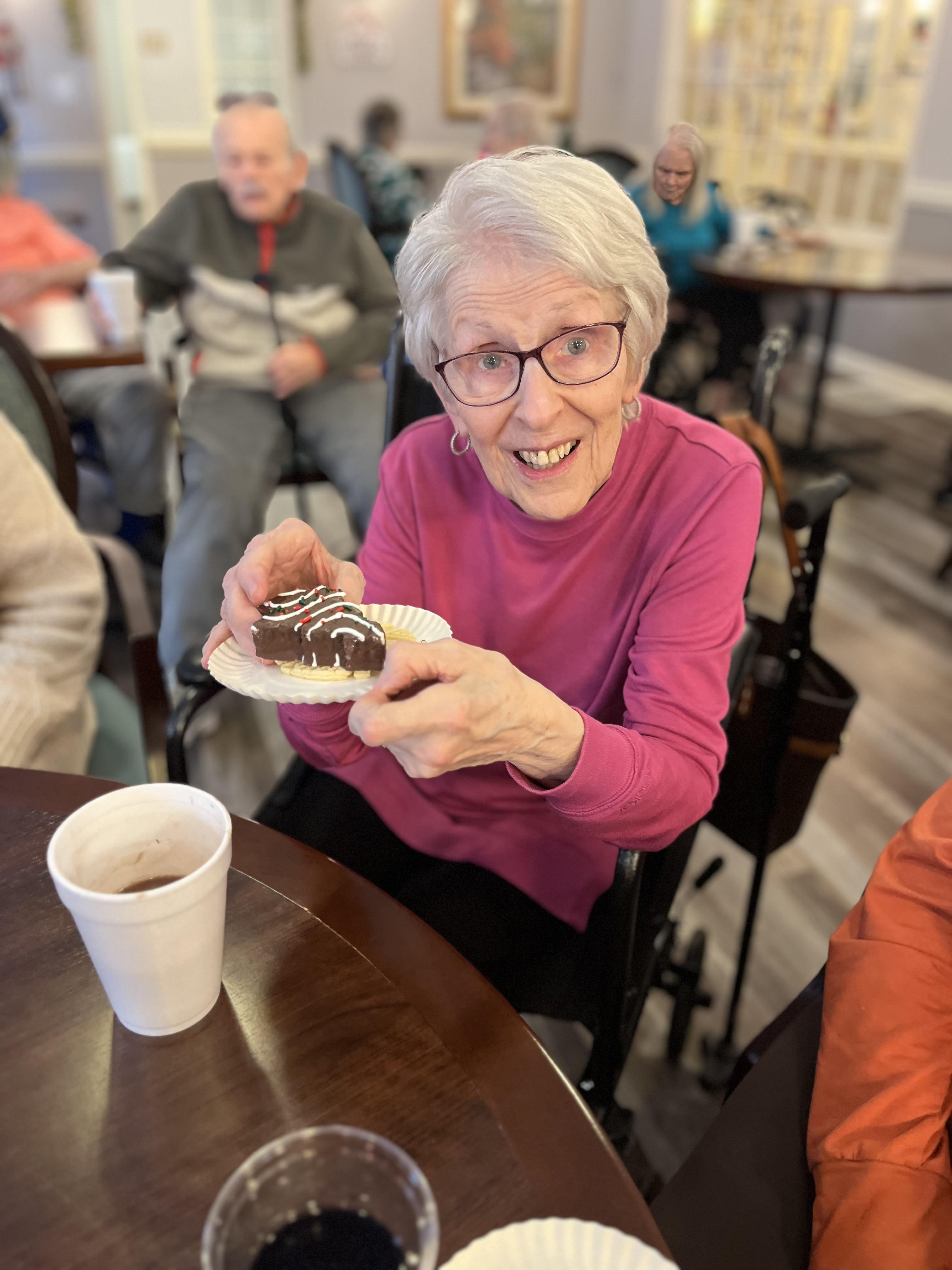 A woman holding a piece of cake