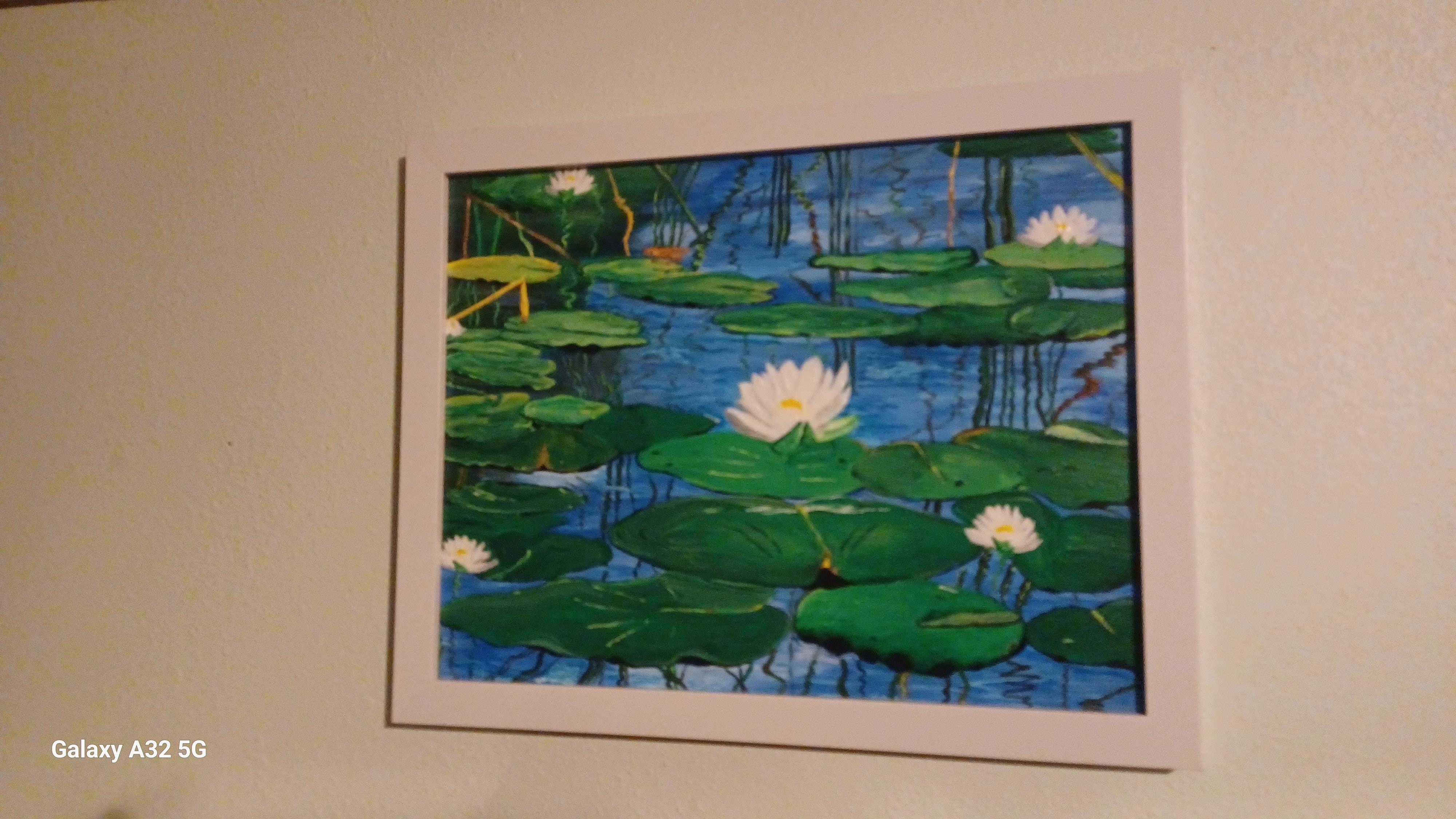 A painting of lily pads on a wall