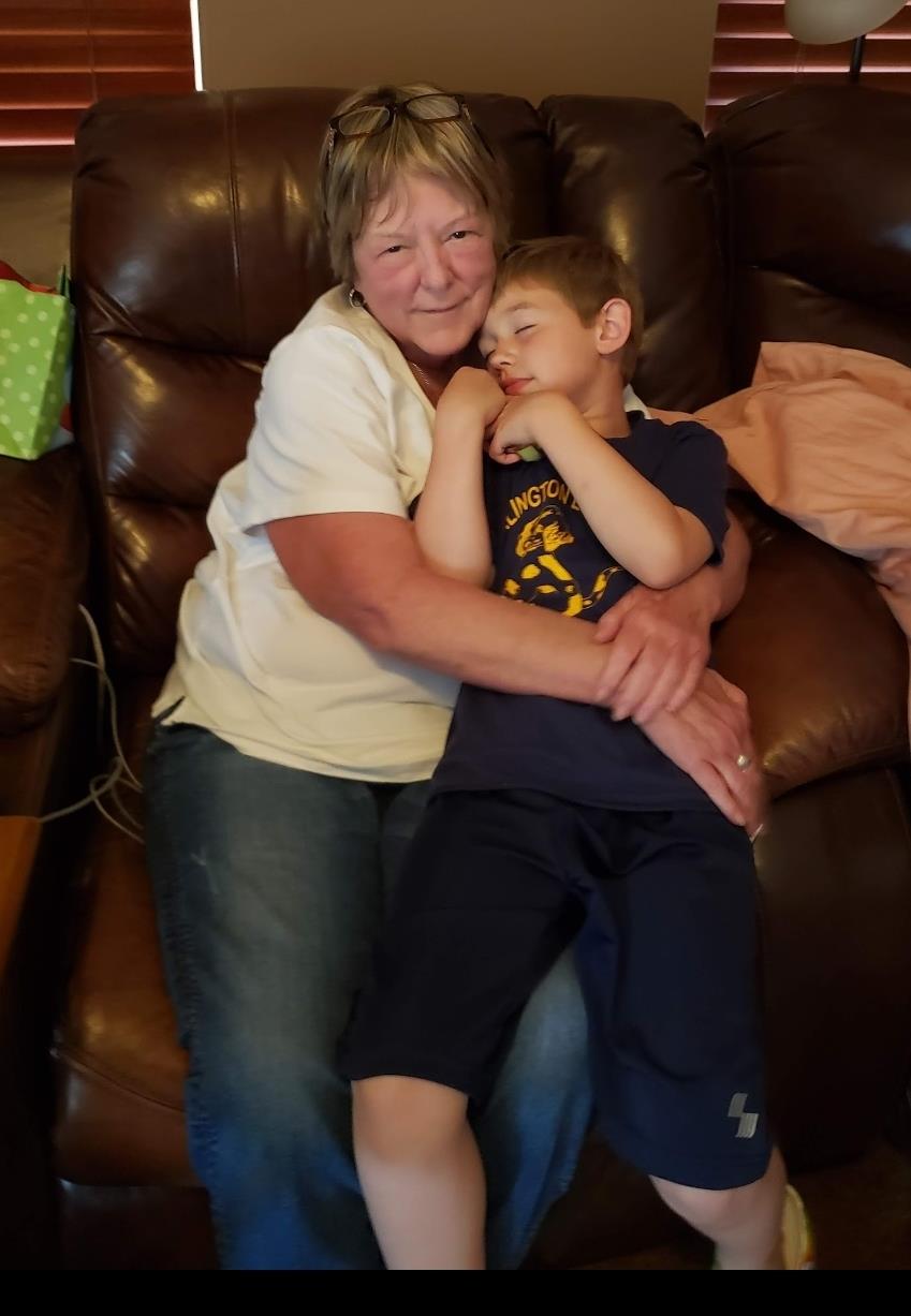 A woman and a boy sitting on a couch
