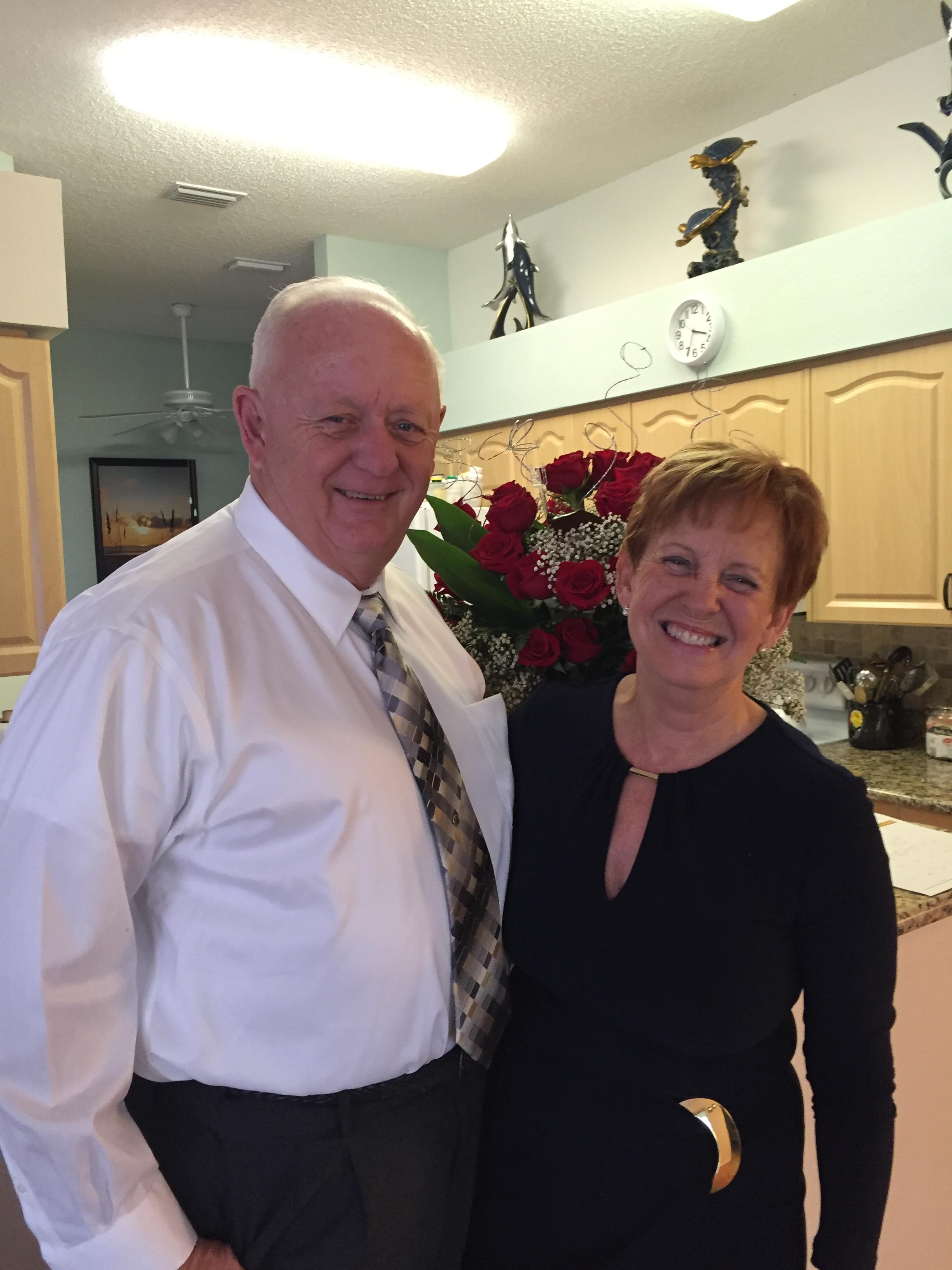A man and woman standing together in a kitchen