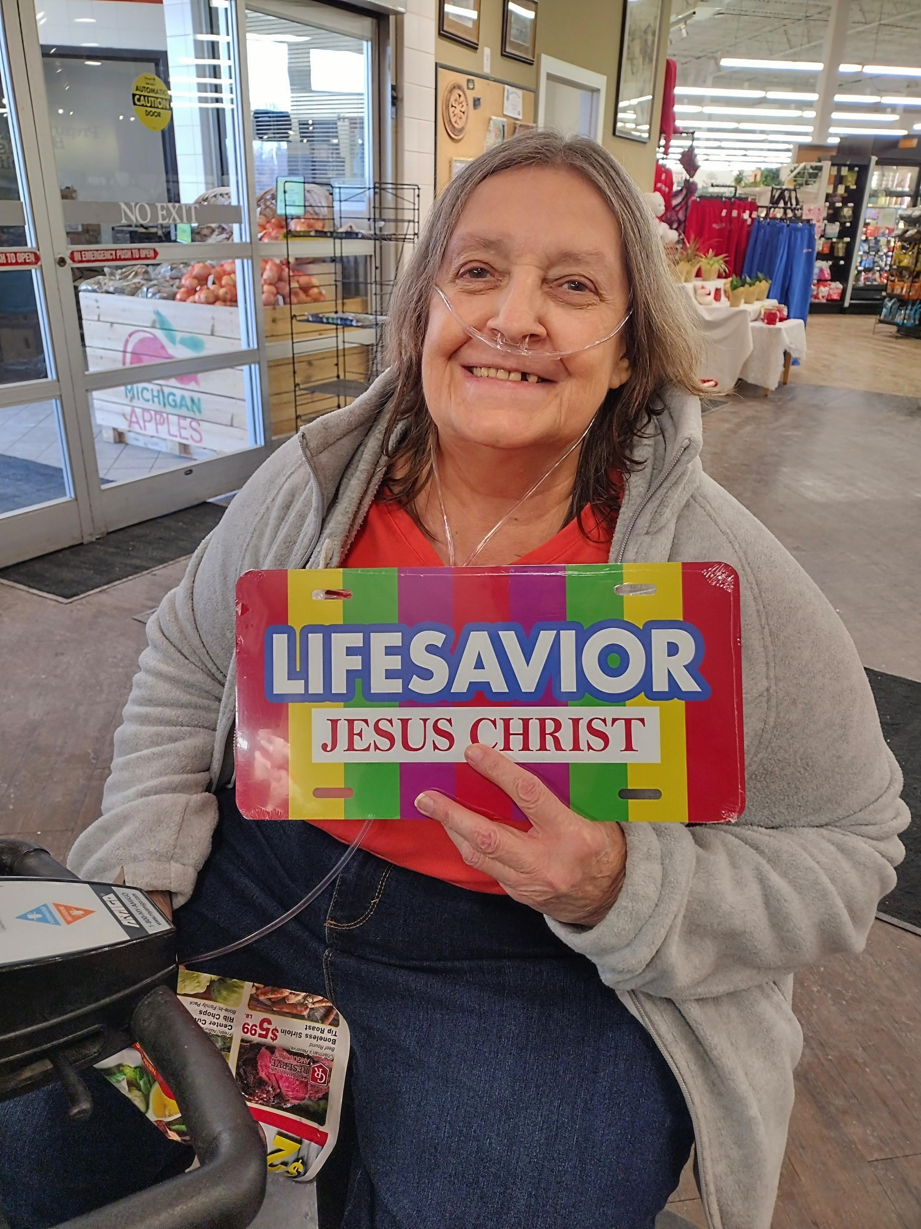 A woman holding a sign