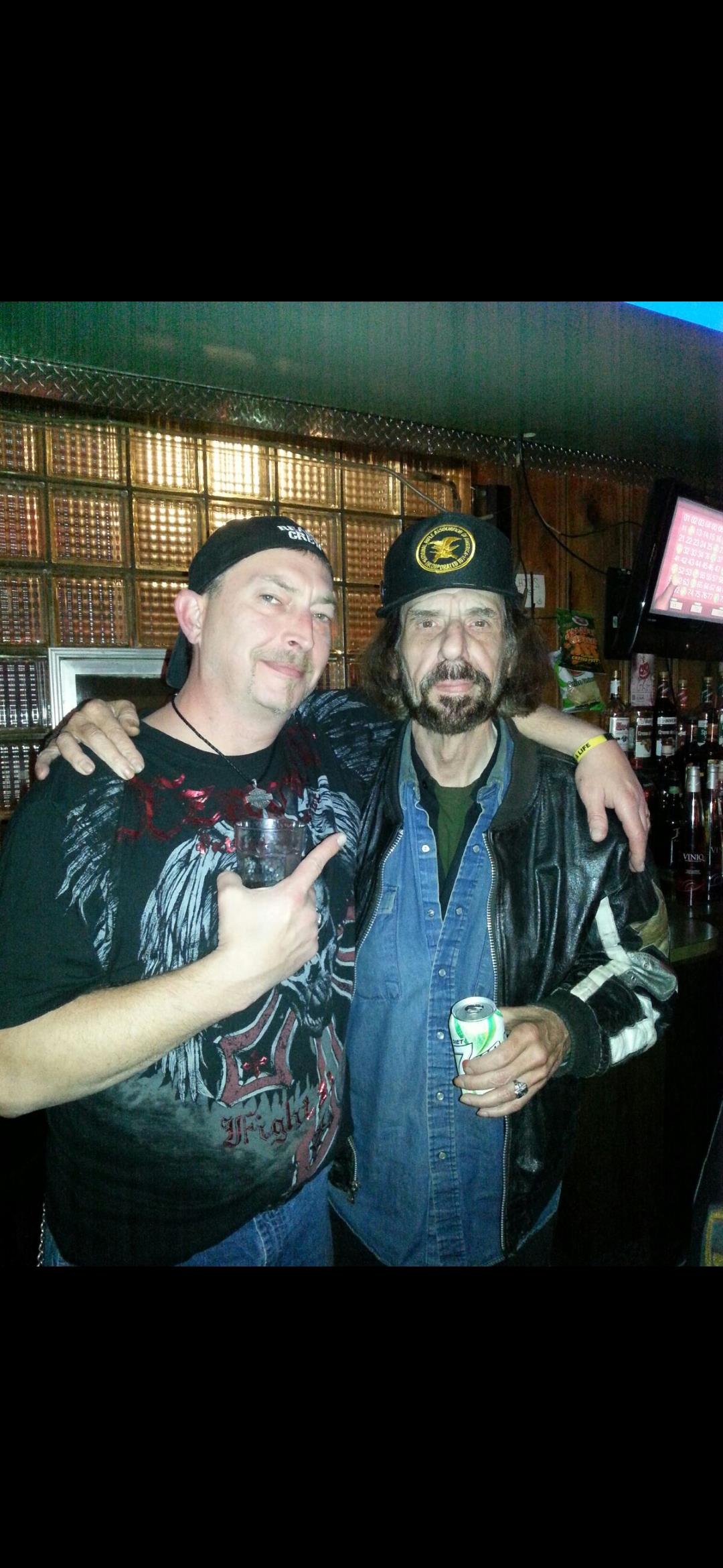 Two men standing together in a bar