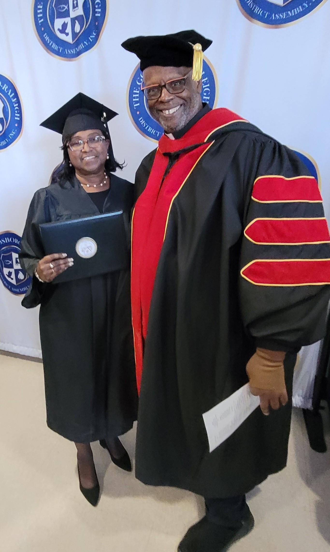 A man and woman in graduation gowns