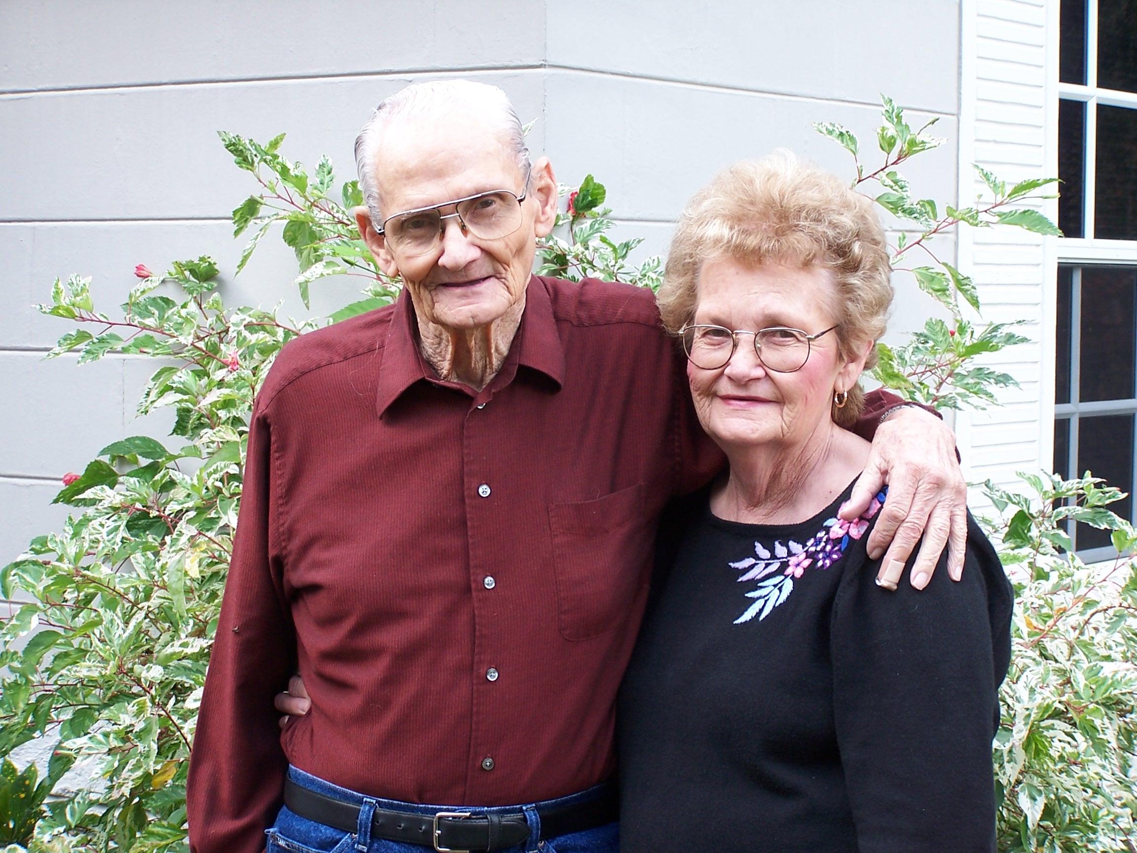 An older man and woman posing for a picture