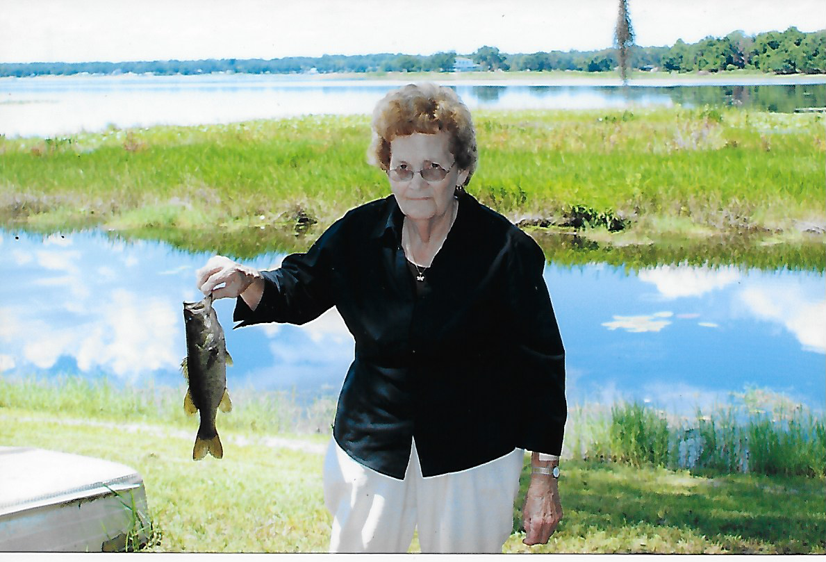 An old woman holding a fish
