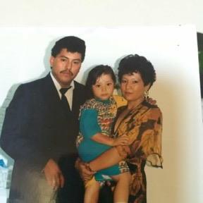 A man and woman holding a child
