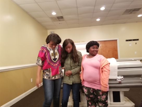 A group of women standing in a room