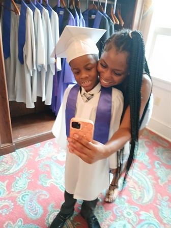A woman taking a selfie with a child