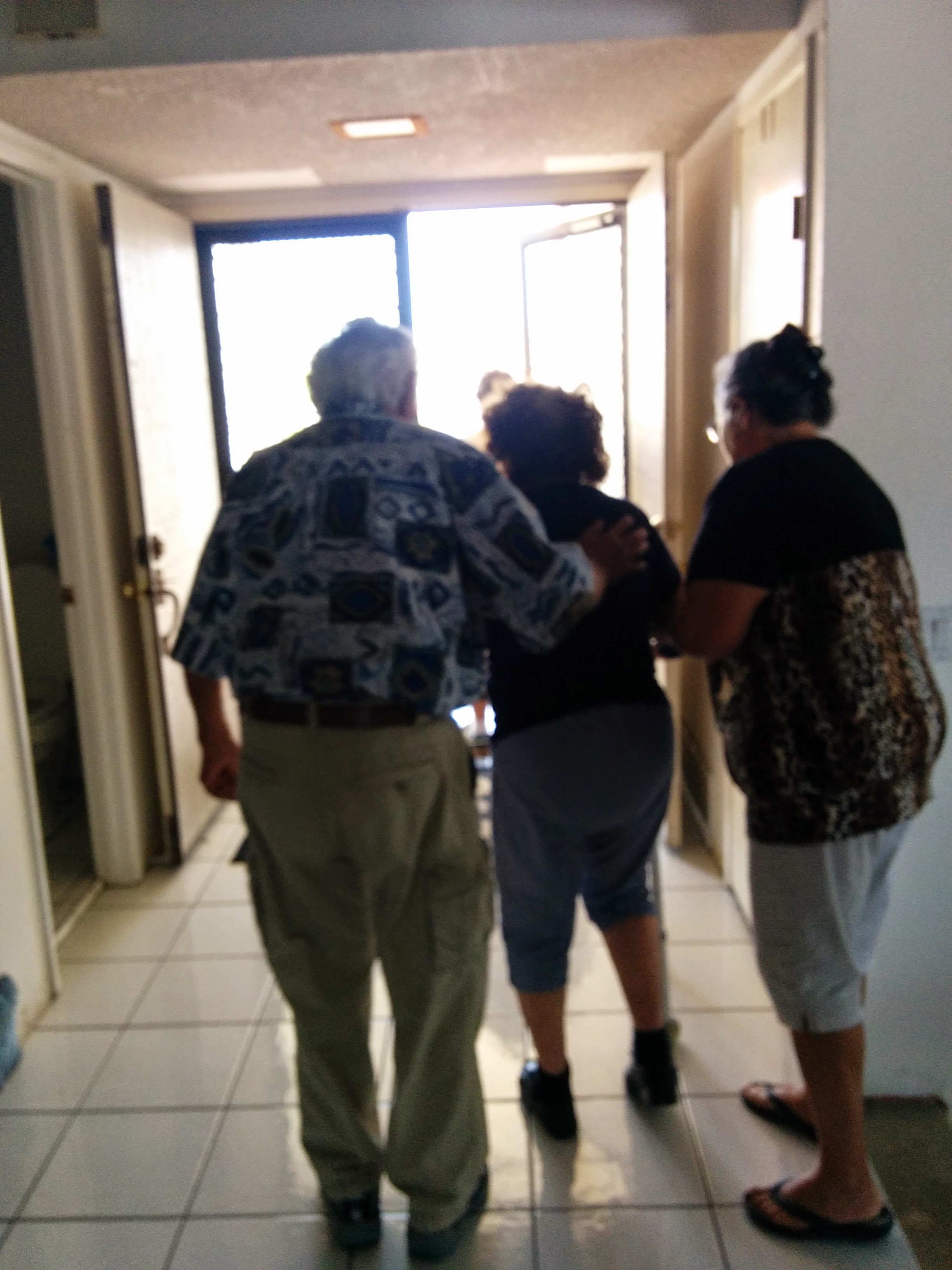 A group of people walking in a hallway