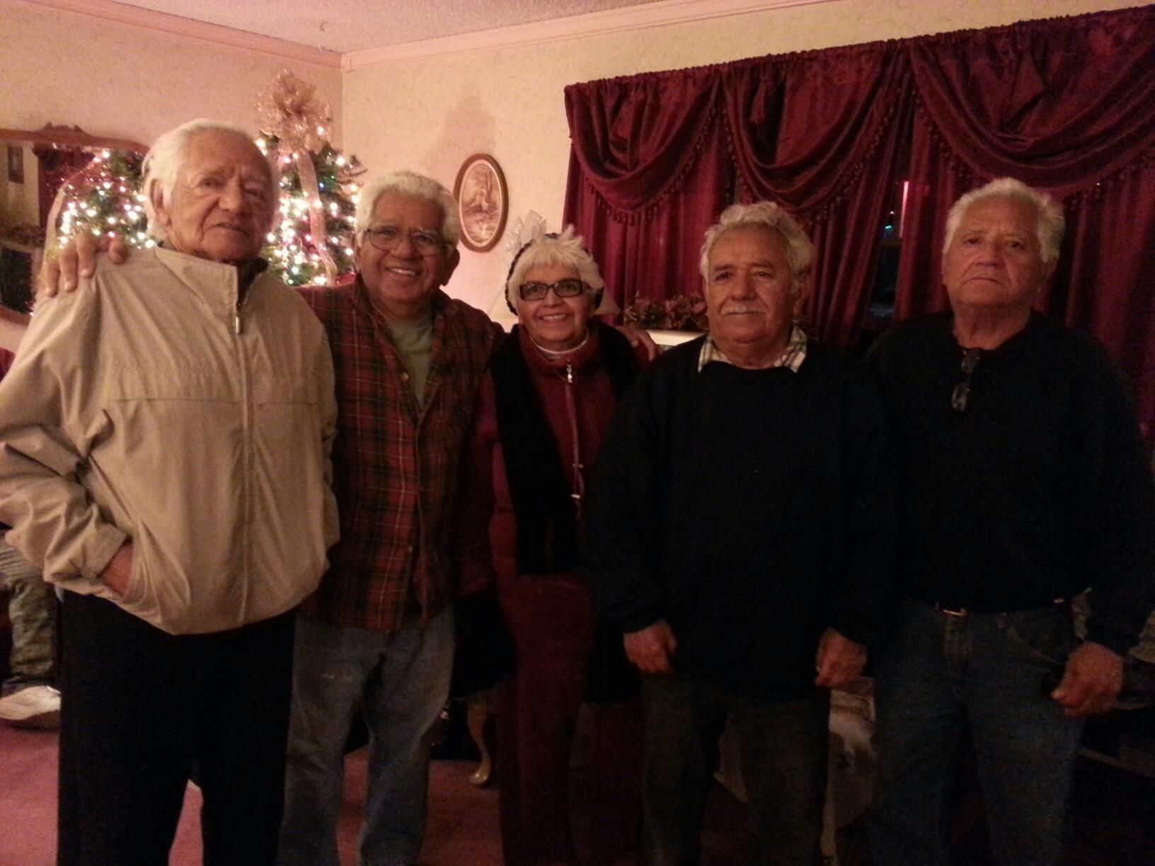 A group of people standing in a room with a christmas tree