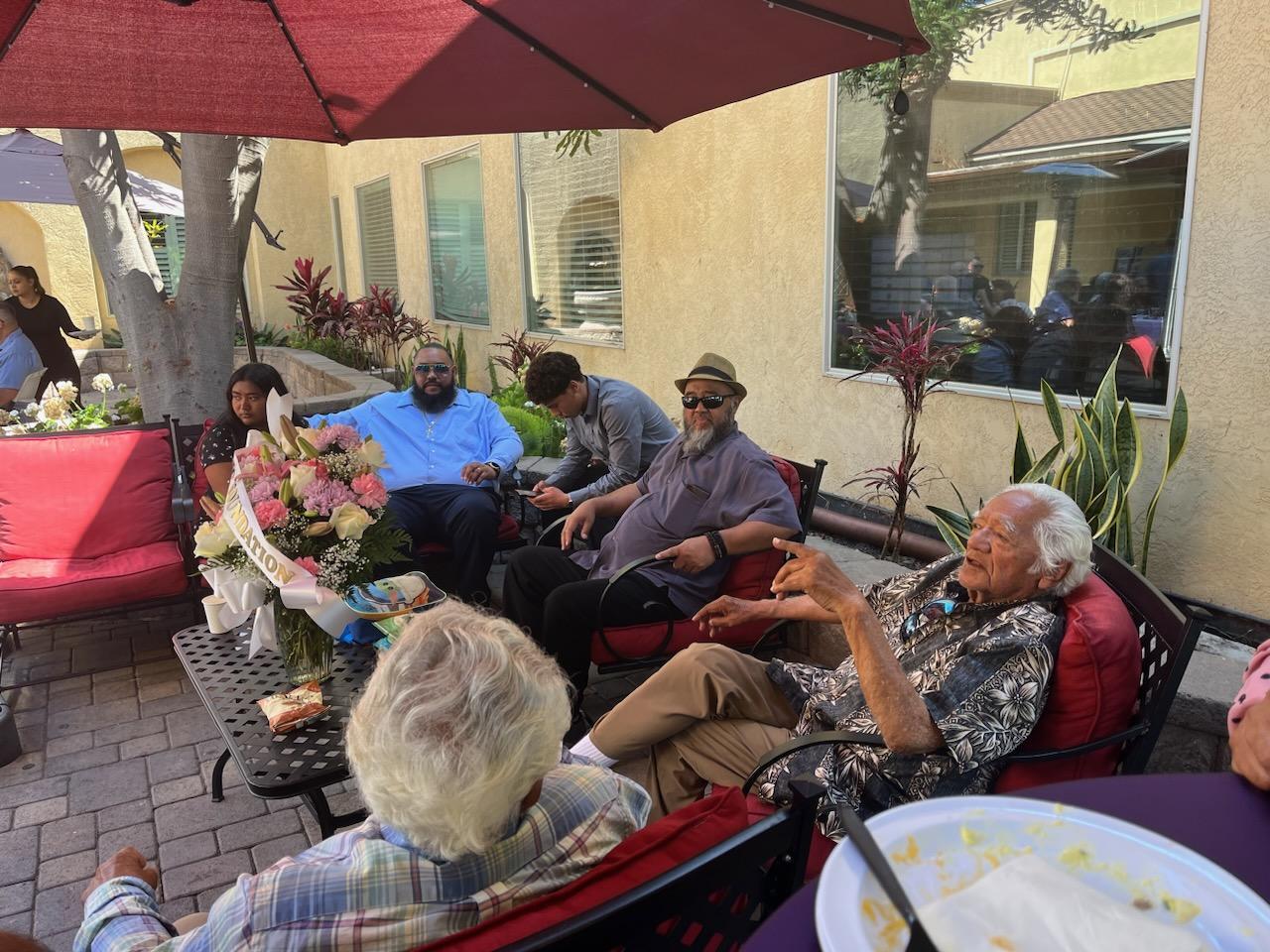 A group of people sitting outside