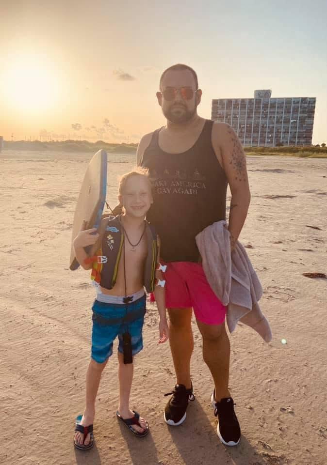 A man and child on a beach
