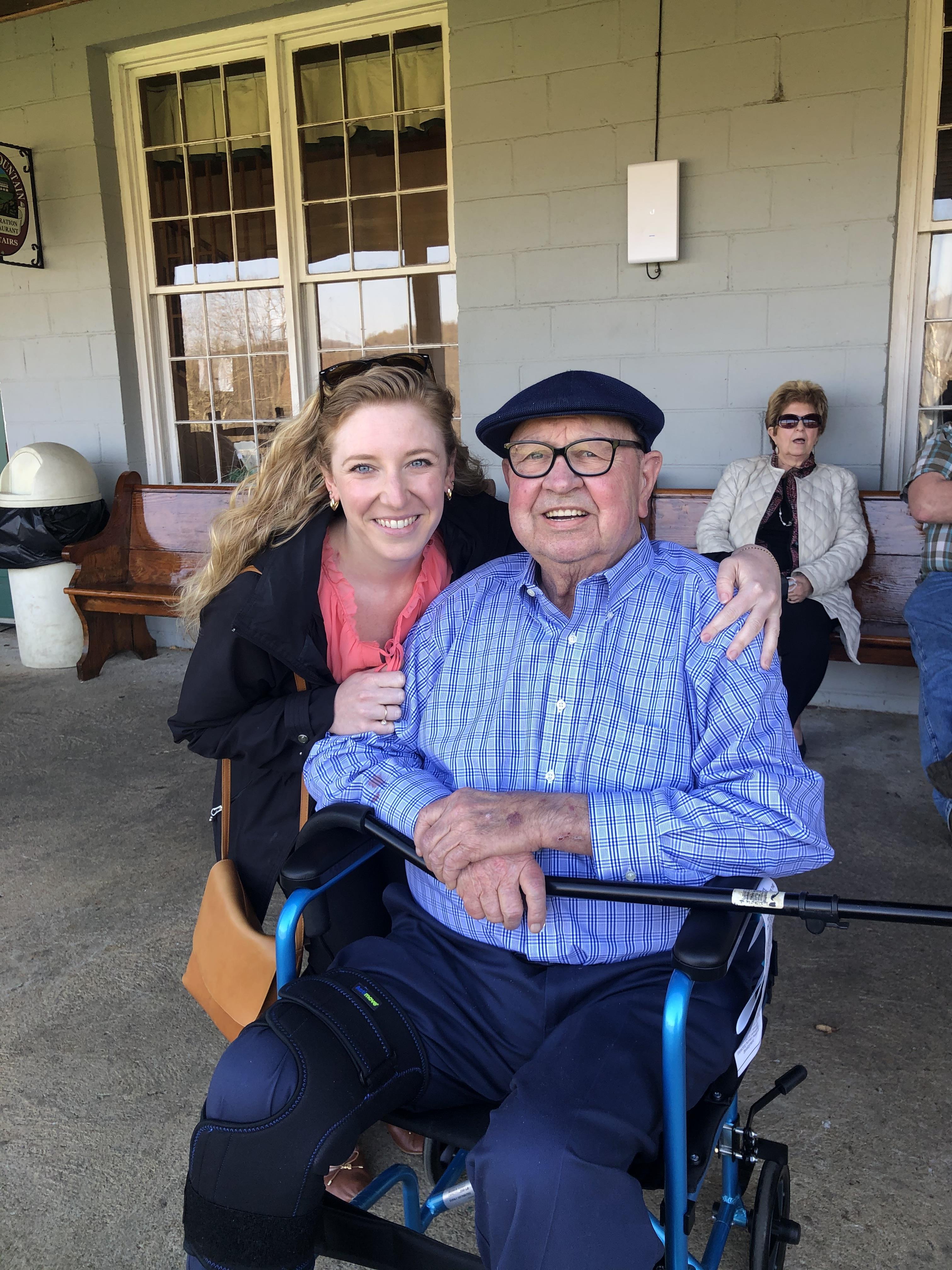 A man in a wheelchair with a woman in the back