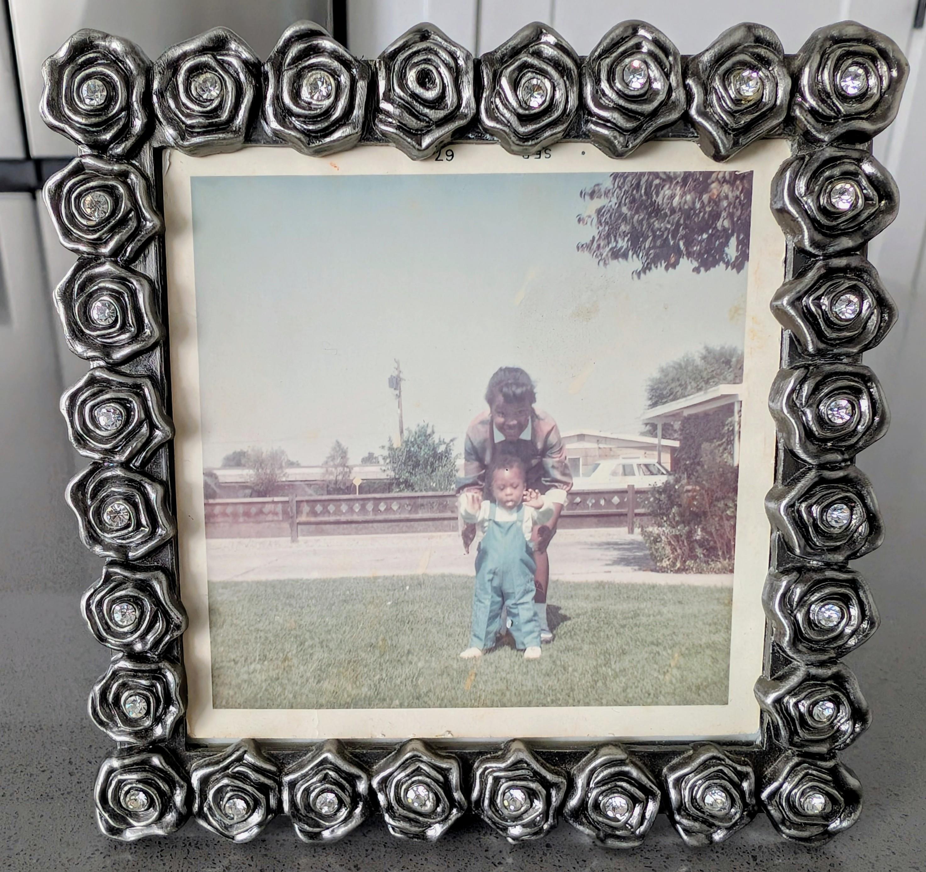 A picture frame with a picture of a child and a girl