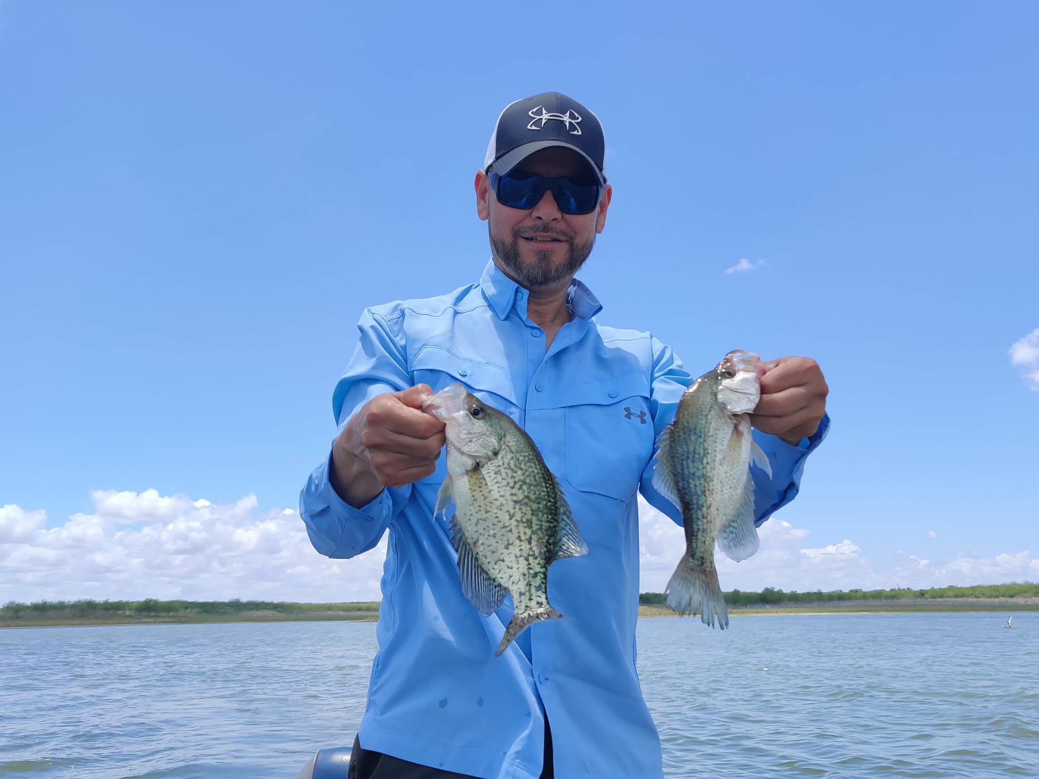 A man holding two fish