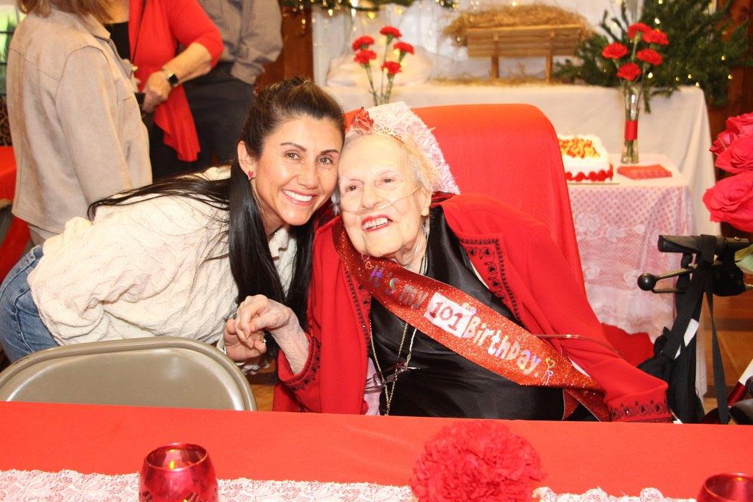 A woman sitting next to an older woman