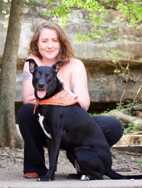 A woman sitting on a dog