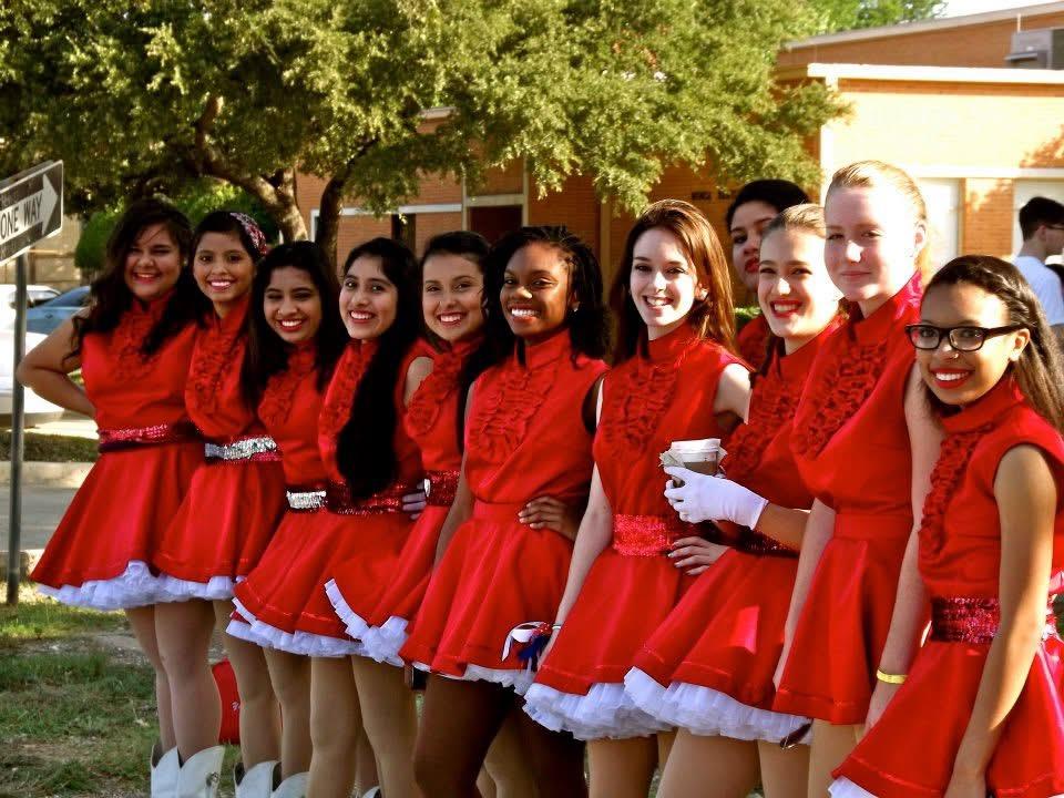 A group of women in red dresses