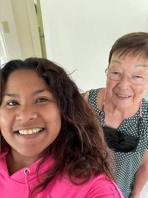 A woman taking a selfie with another woman