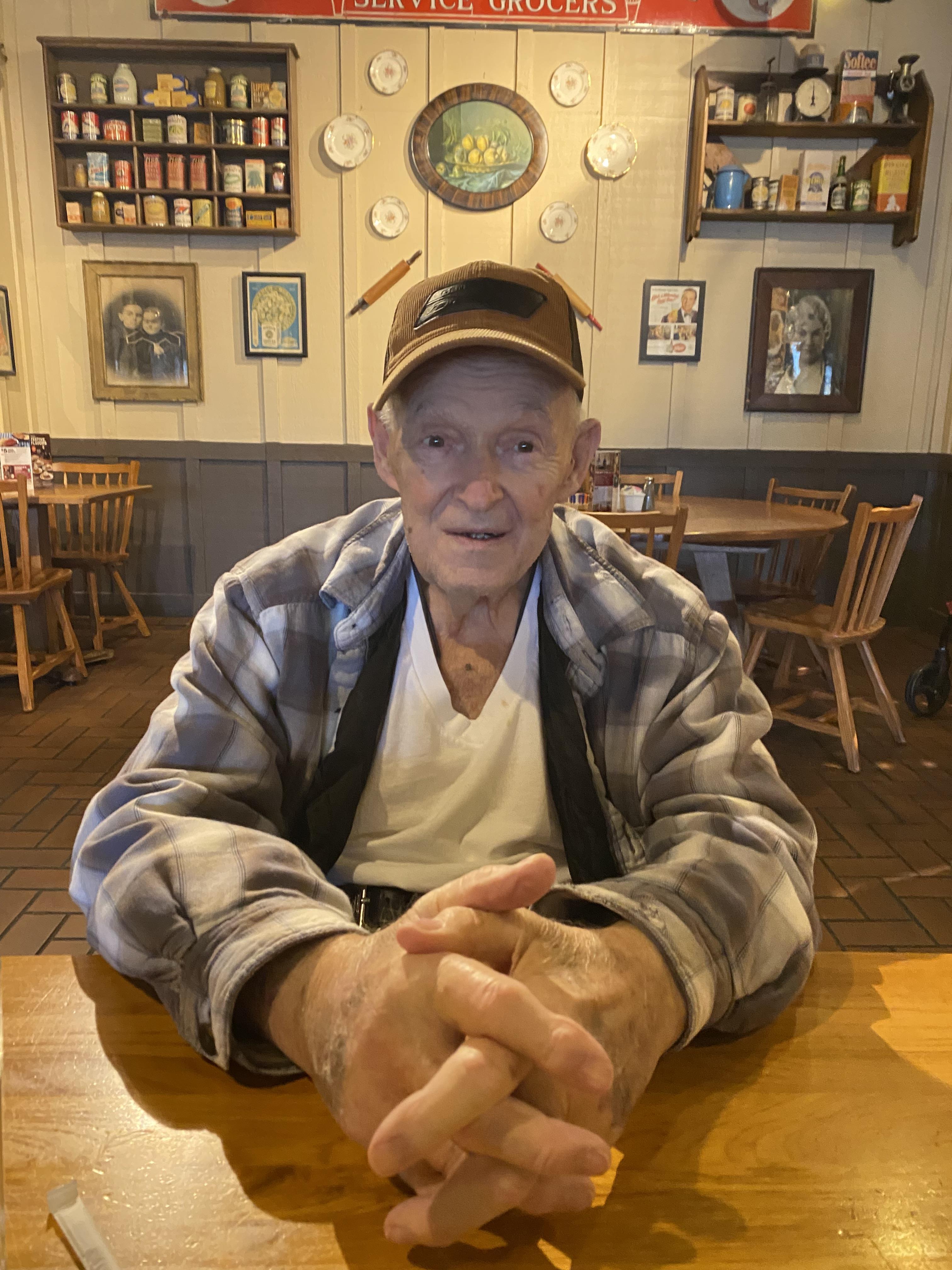 An old man sitting at a table
