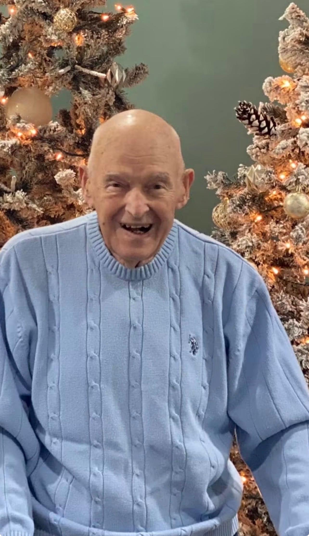 A man in a blue sweater