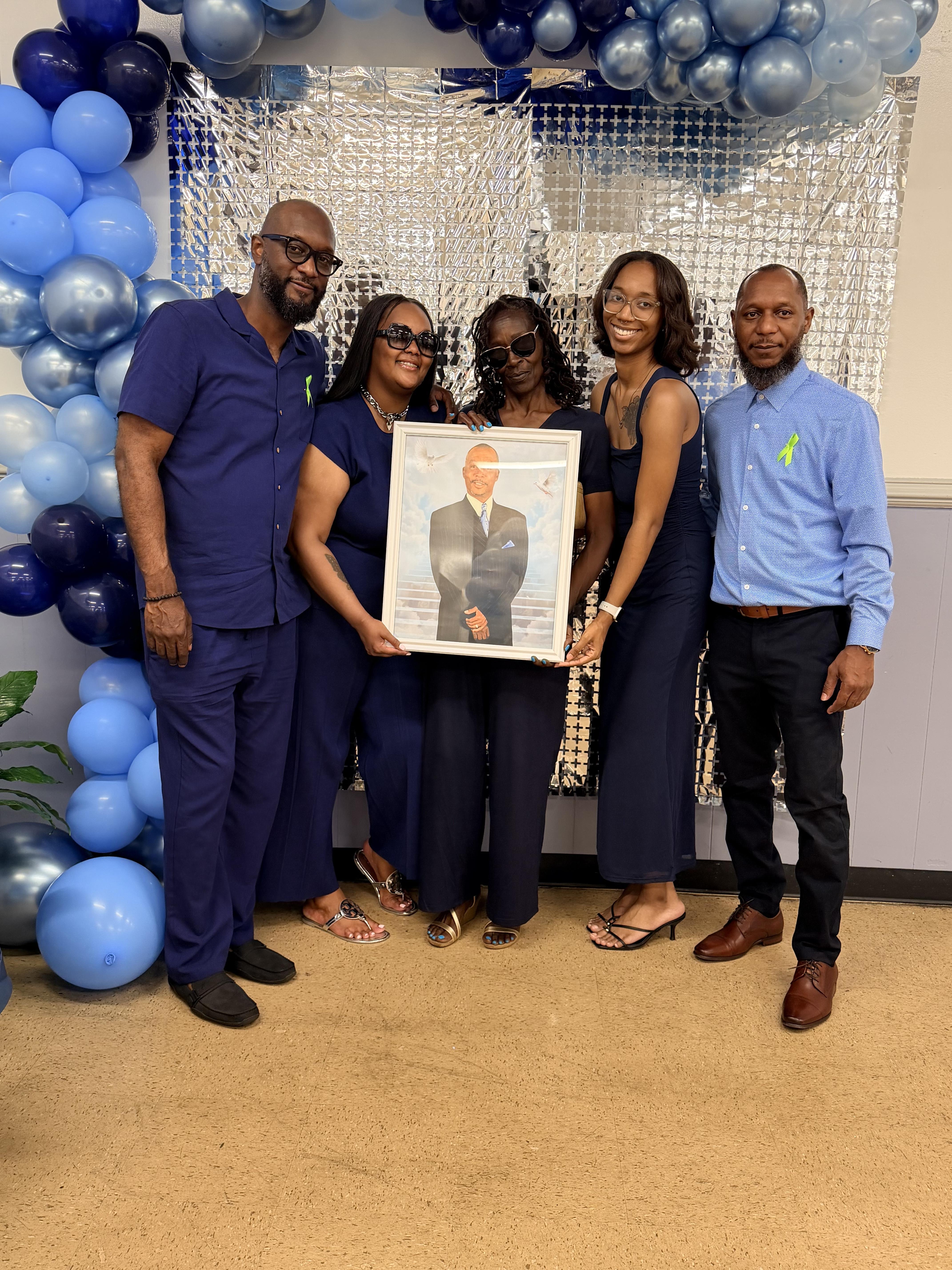 A group of people holding a picture
