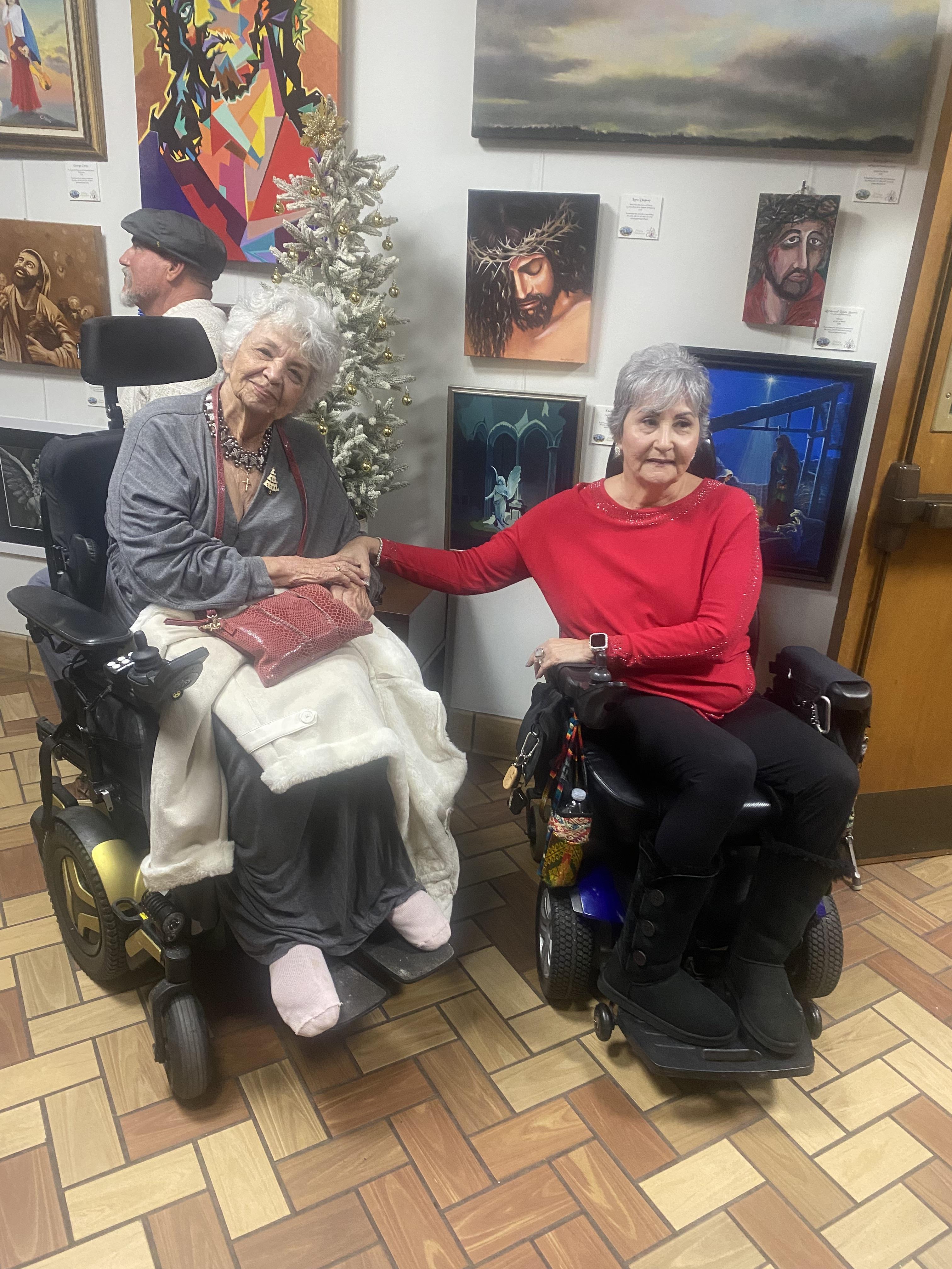 Two women in wheelchairs in a room