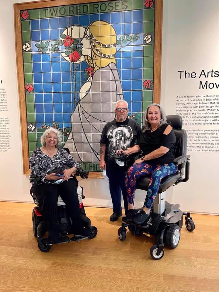 A group of people in wheelchairs posing for a picture