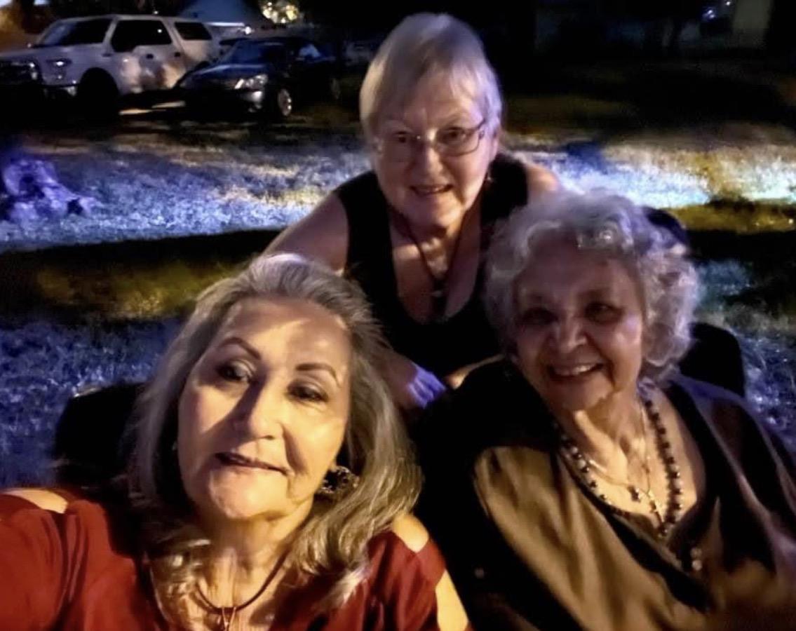 A group of women sitting together outside