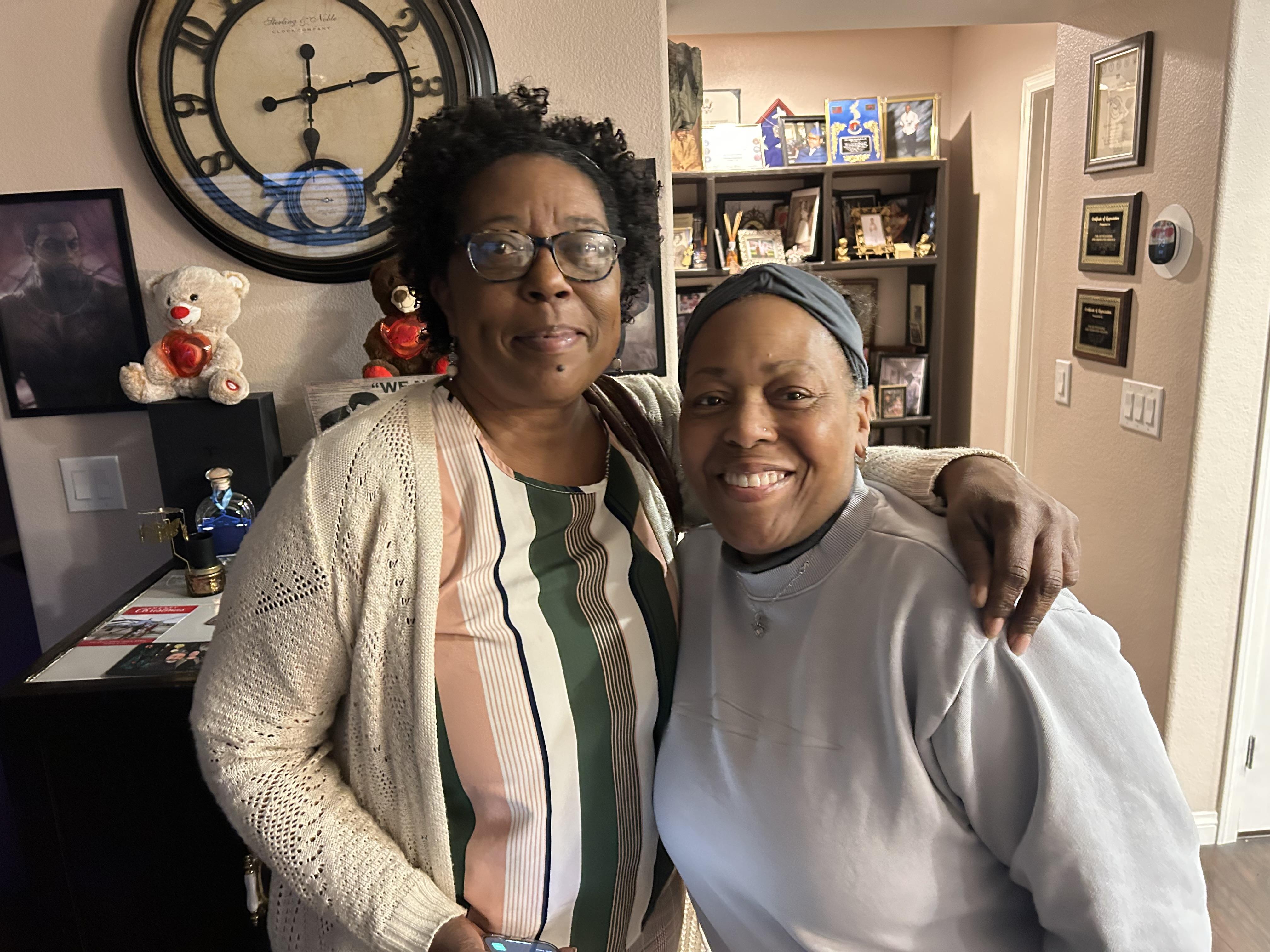 Two women standing together in a room