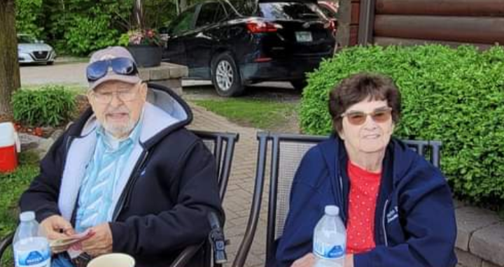 A man and woman sitting outside