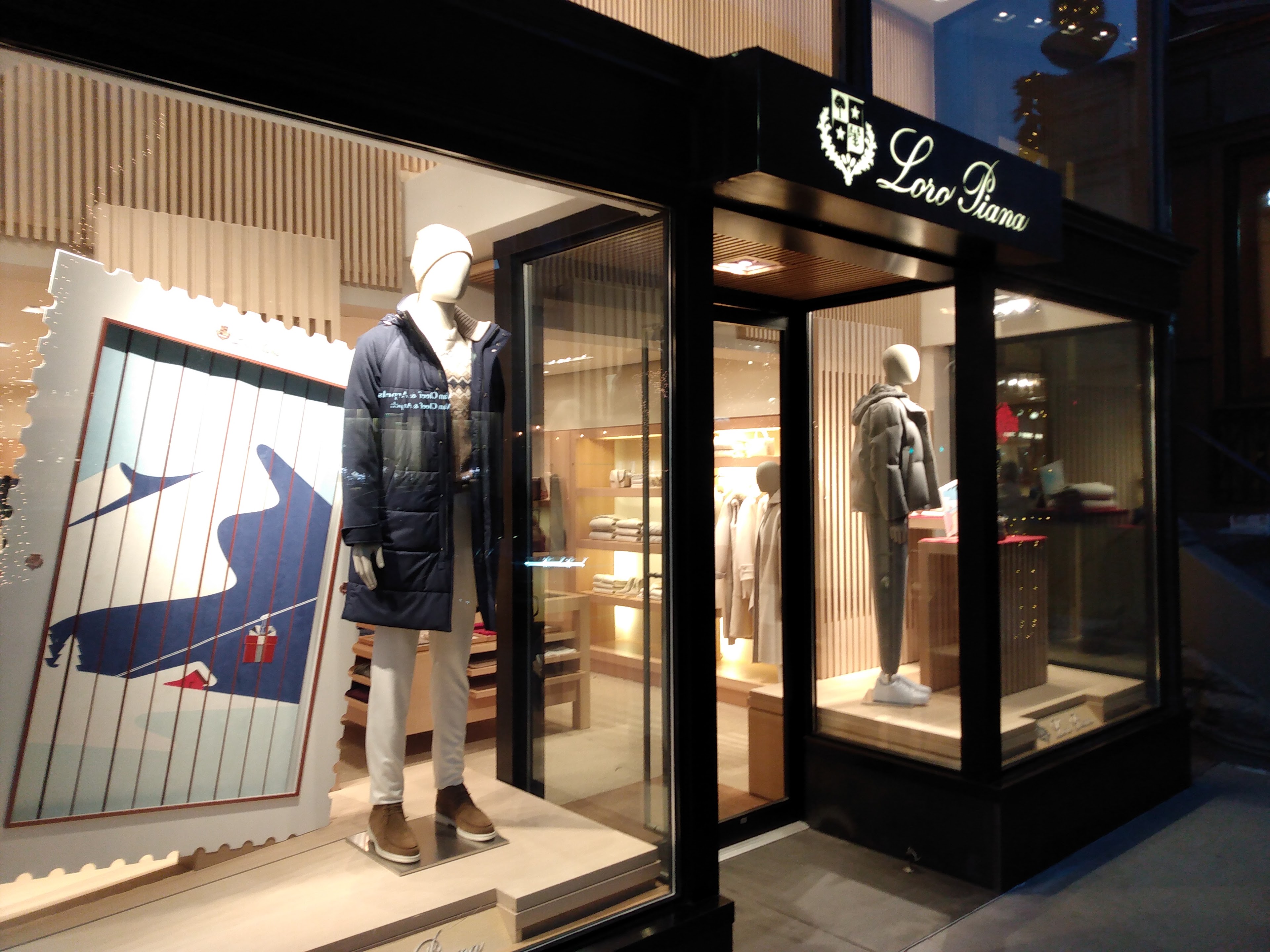 A store front with mannequins in a jacket