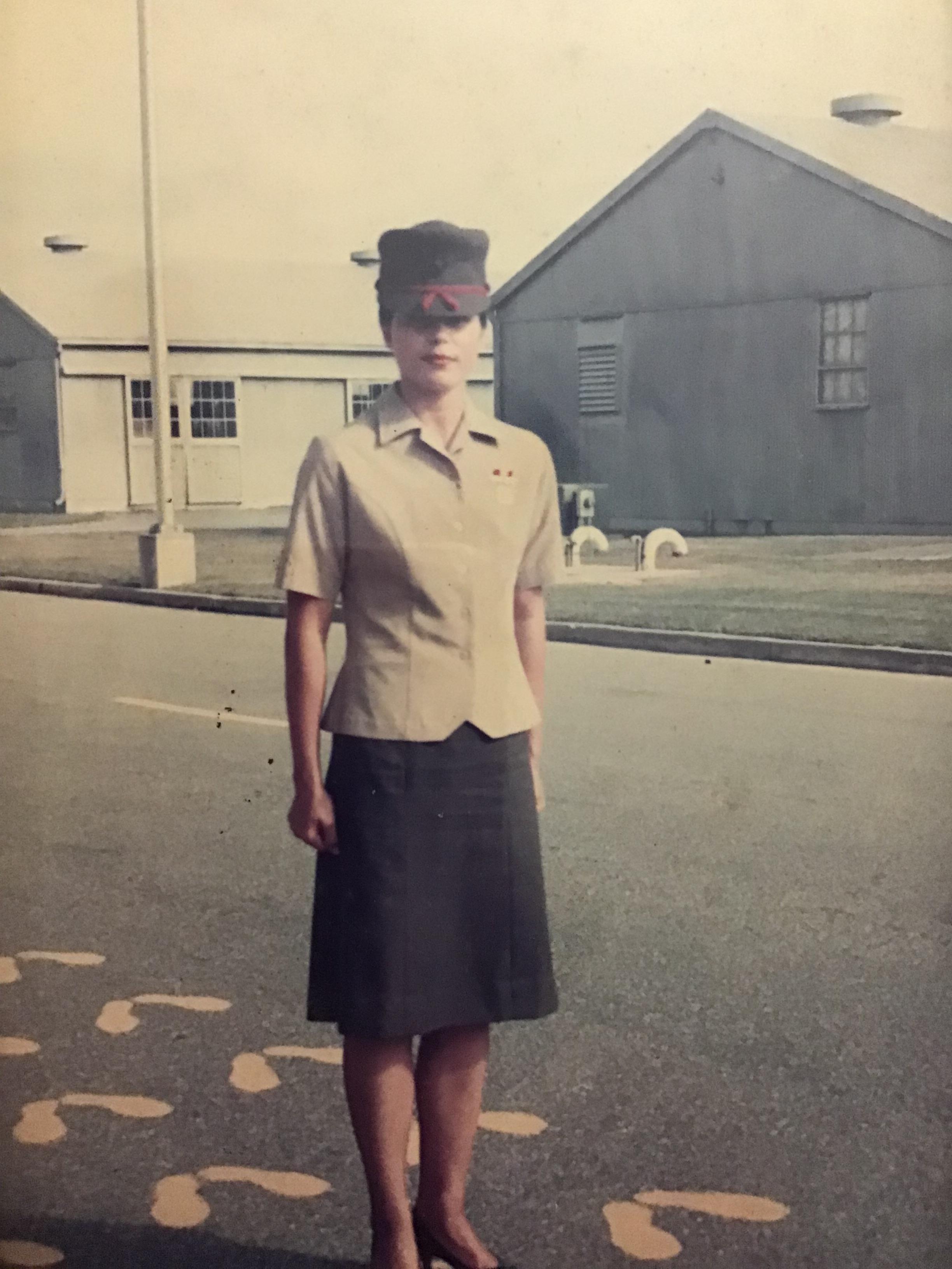 A woman in uniform standing on the street