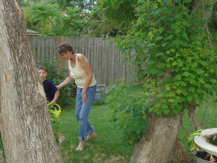 A woman and boy playing in the yard