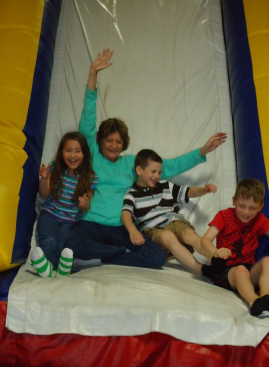 A woman and children on a slide
