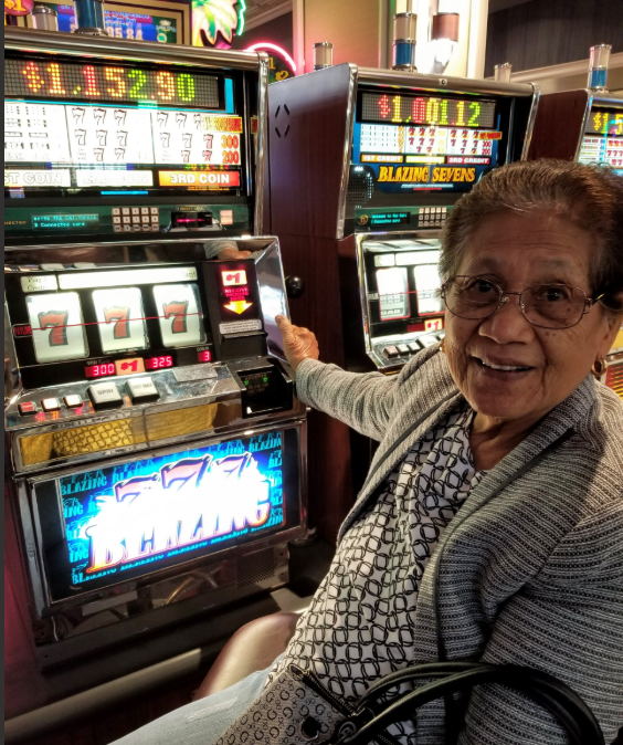 A woman sitting in a chair at a slot machine