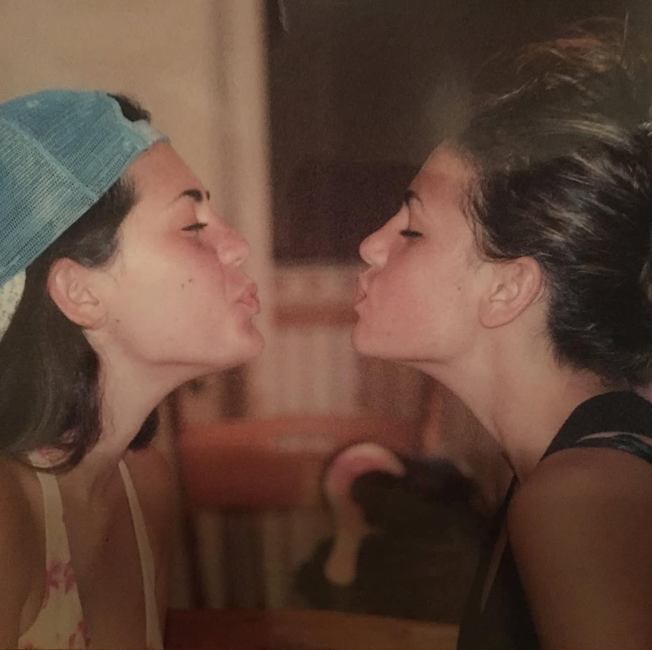 Two women kissing each other