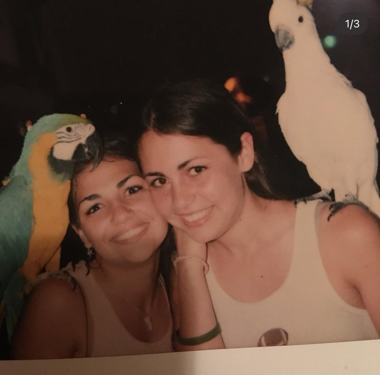 A woman with a parrot on her shoulder