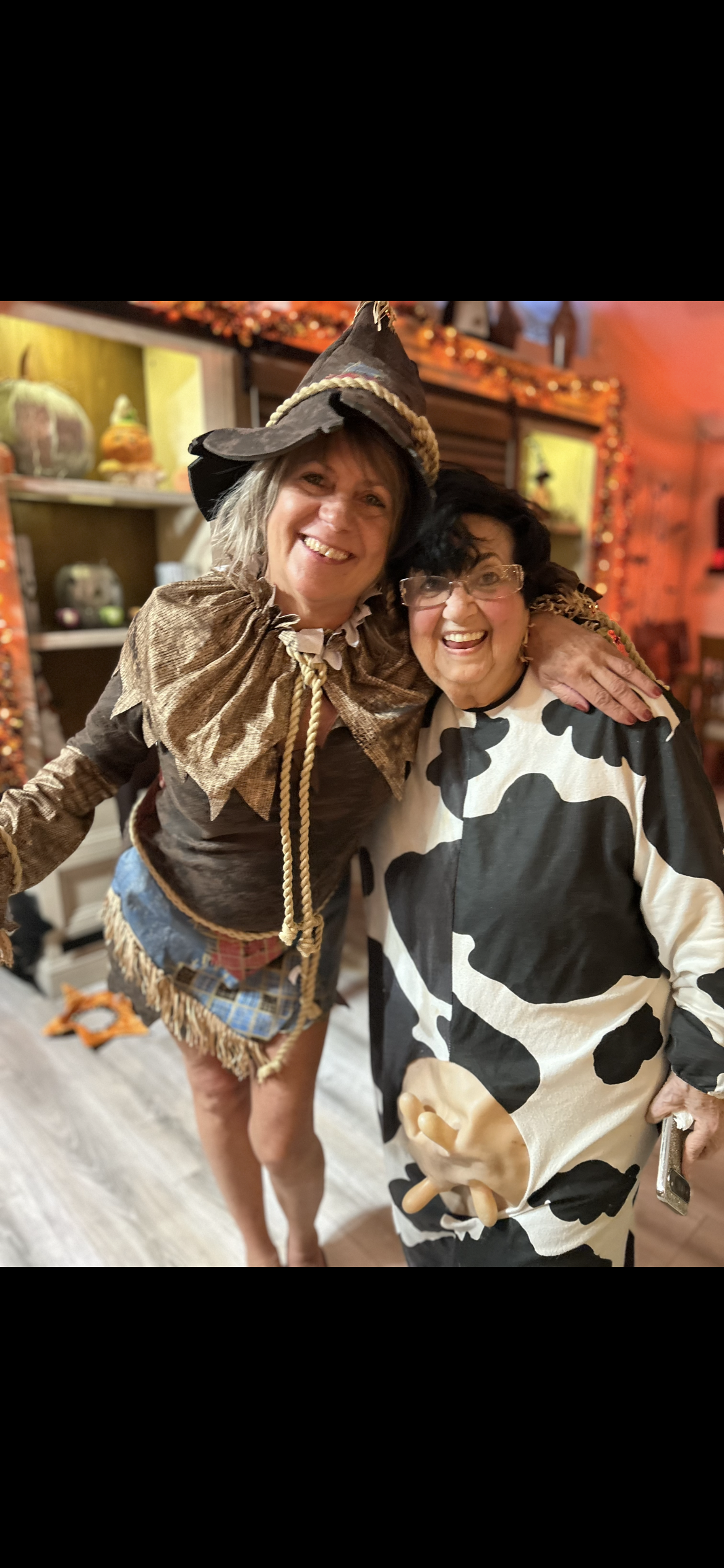 Two women in clothing posing for a picture