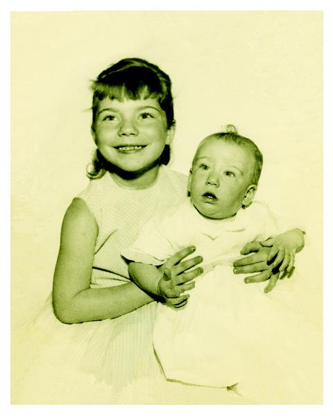 A girl holding a baby