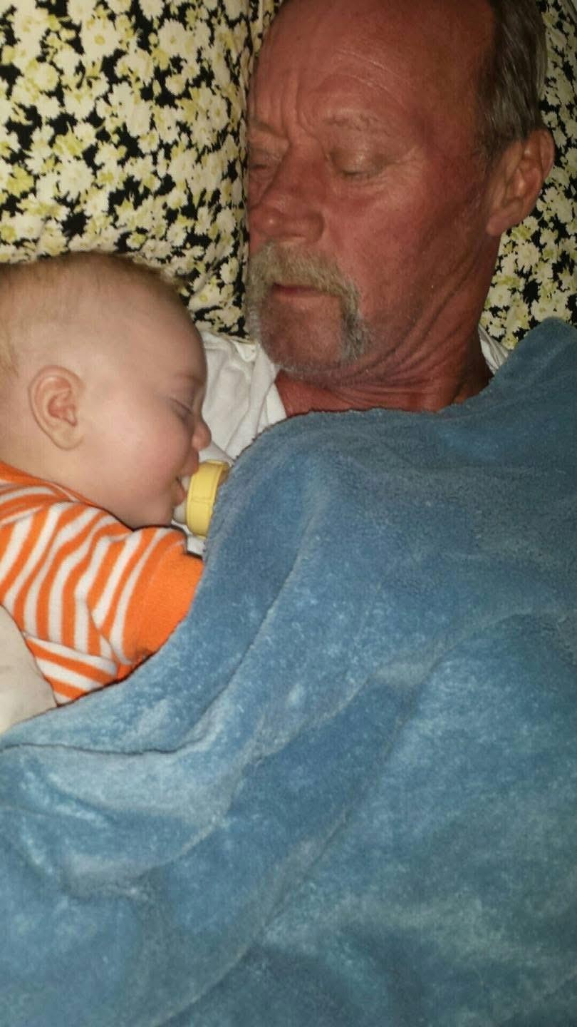 A man lying down with a baby