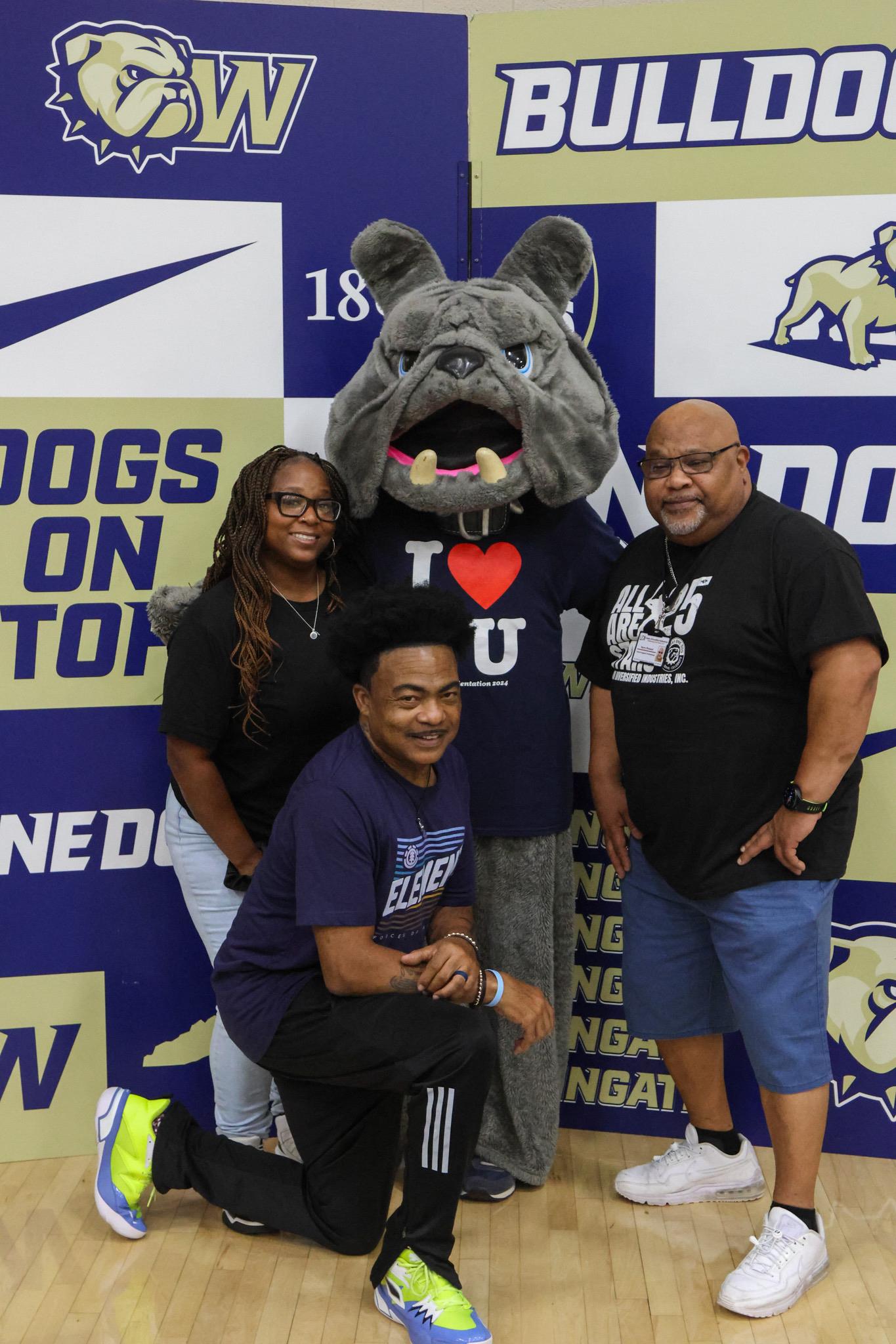 A group of people posing for a picture with a mascot