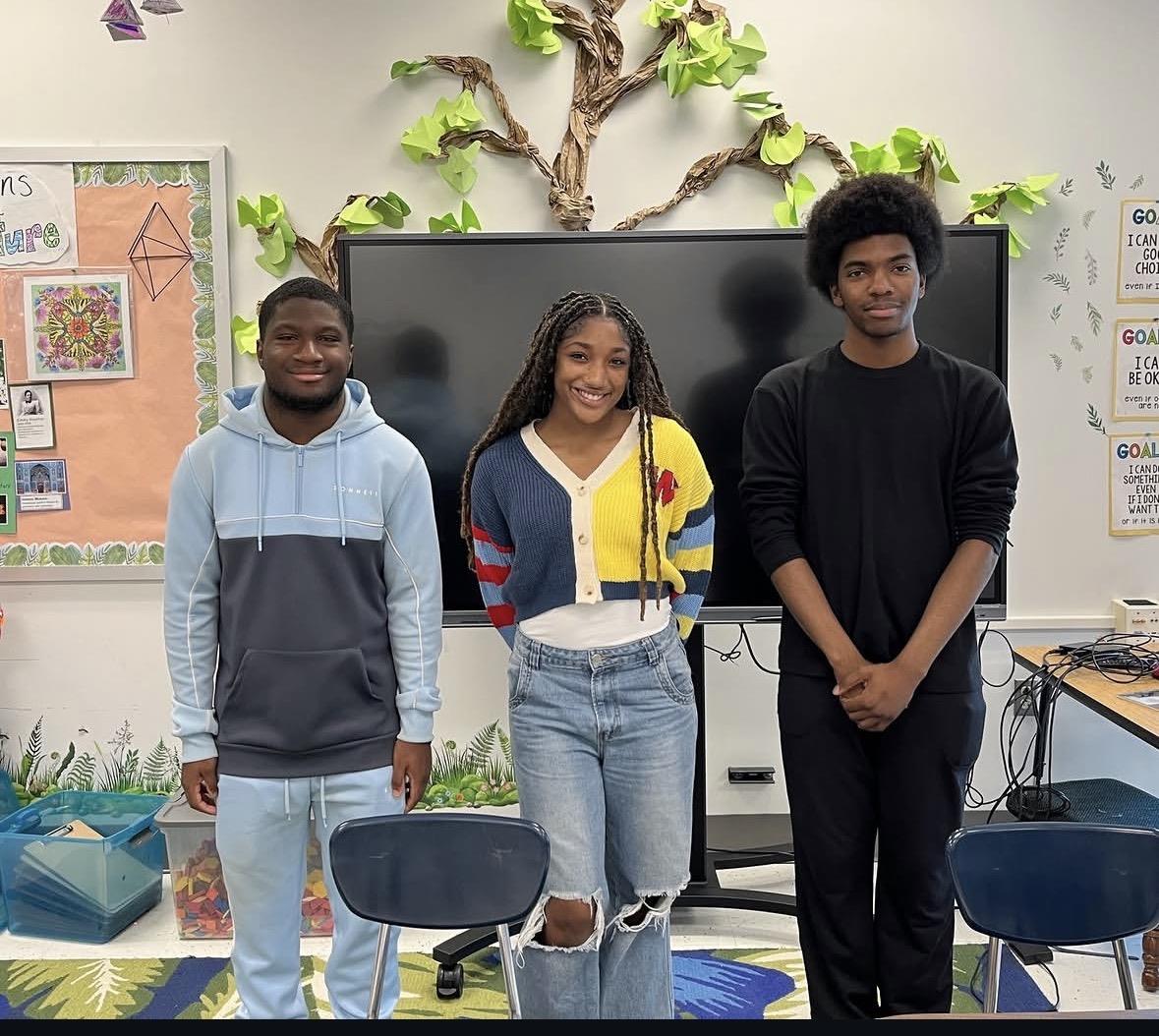 A group of people standing in a classroom