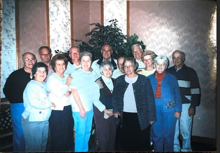A group of old people posing for a photo