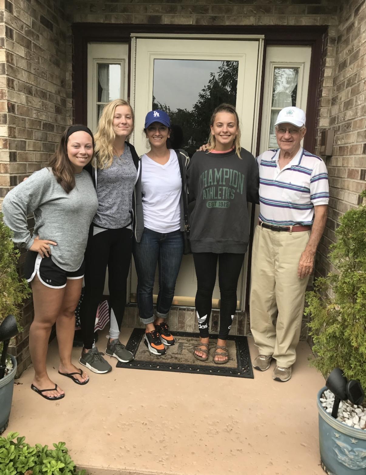 A group of people standing in front of a door