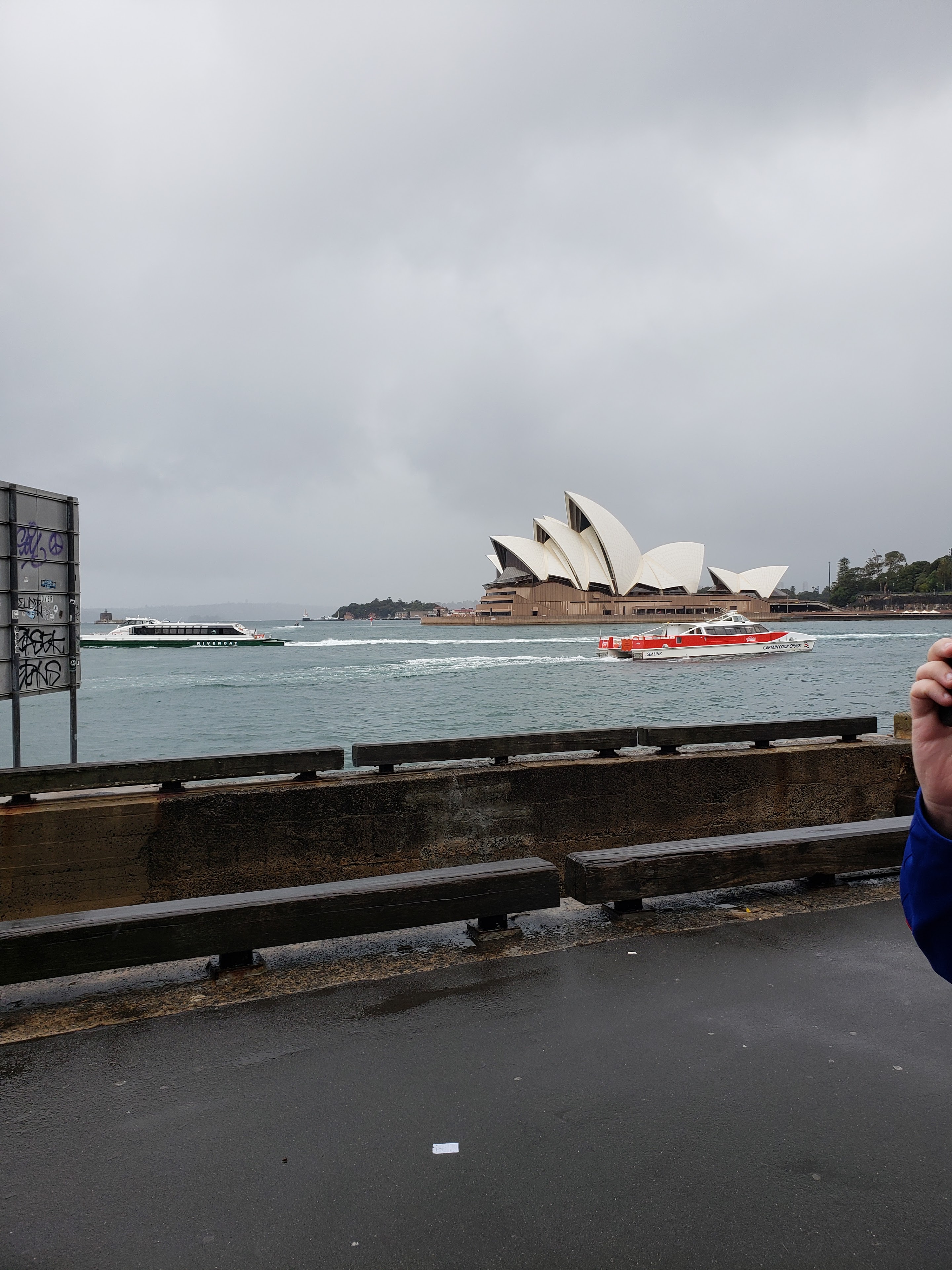 A person taking a picture of a building in the background