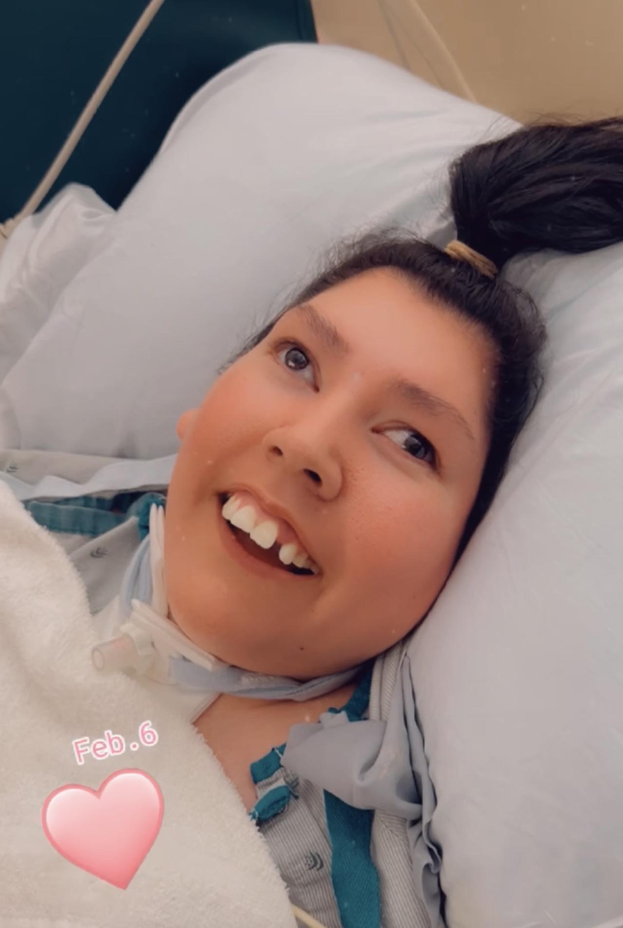 A woman lying in a hospital bed