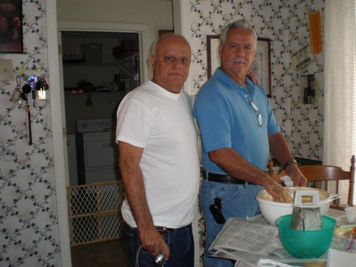 A couple of men standing in a kitchen