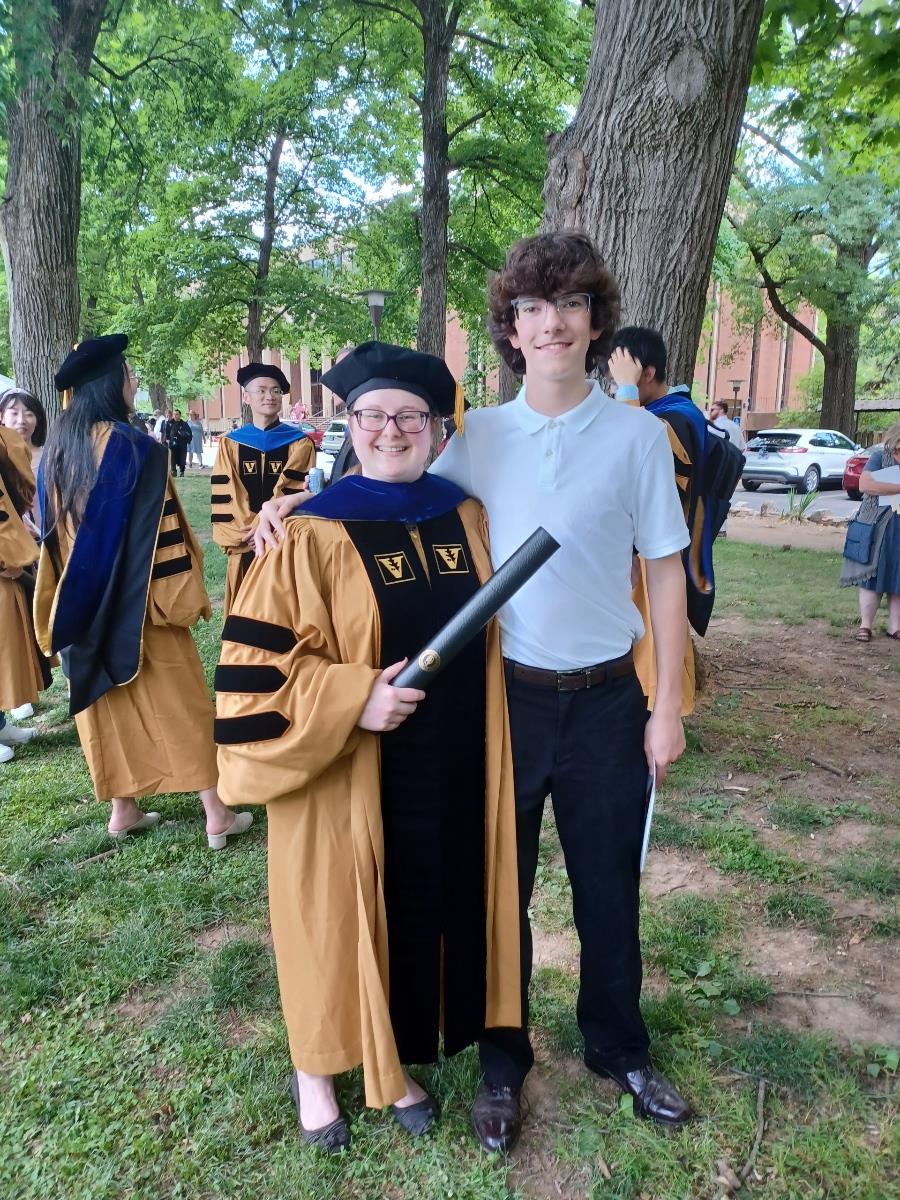A man and woman in graduation gowns