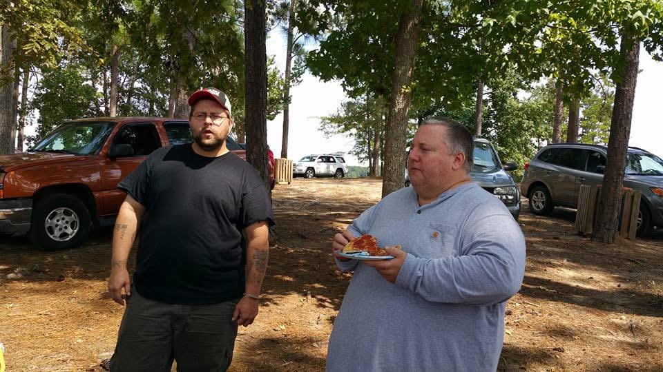 A man standing next to another man